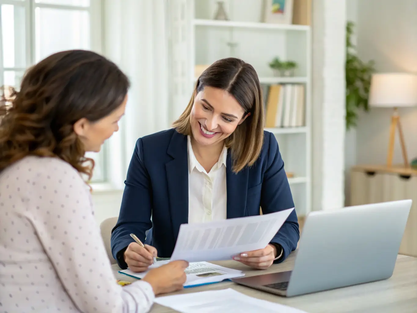 An image of a financial advisor in a modern office setting, discussing financial plans with a client at a table, both smiling and engaged in conversation, symbolizing personalized financial planning.